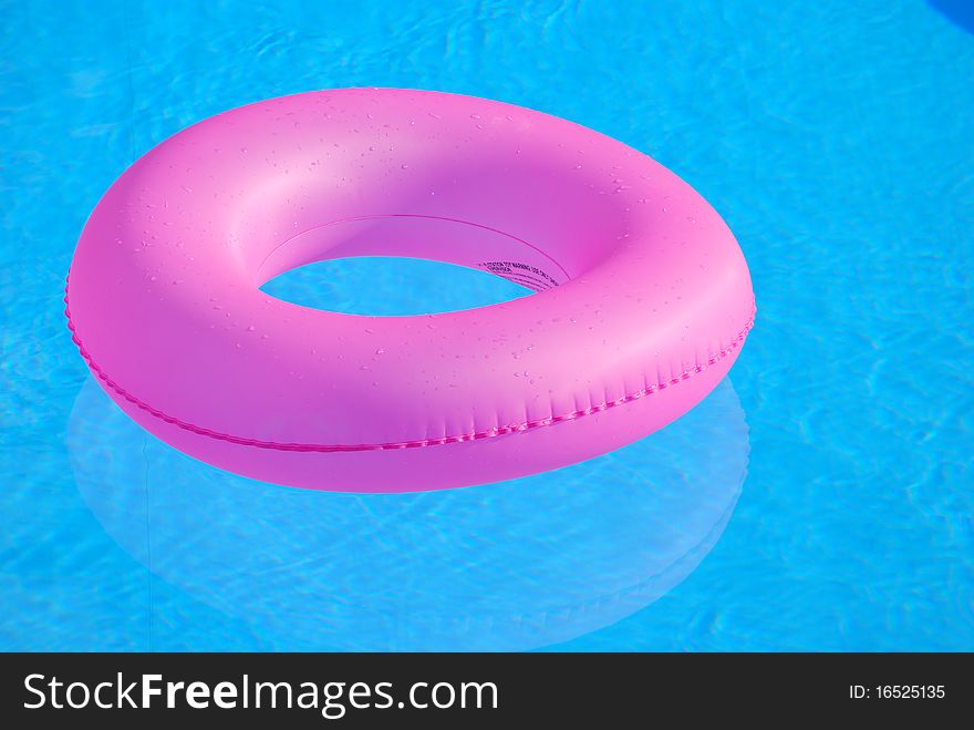 Pink round floating devise in swimmingpool. Pink round floating devise in swimmingpool