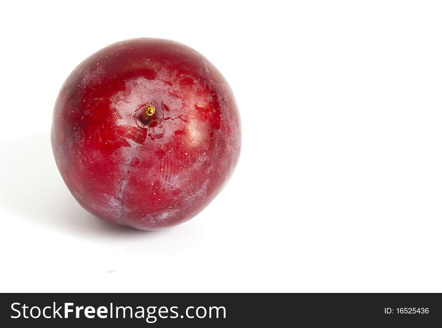 One red plum isolated on white. One red plum isolated on white