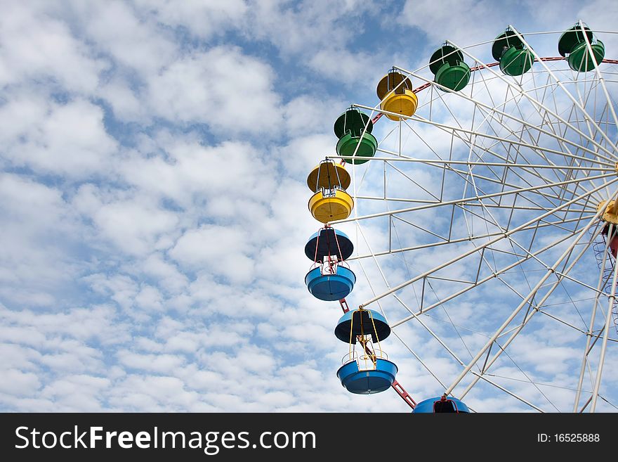 Ferris wheel on sky background