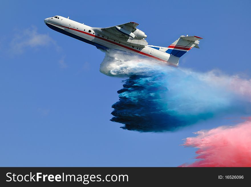 Firefighter airplane spraying tricolor cloud of water