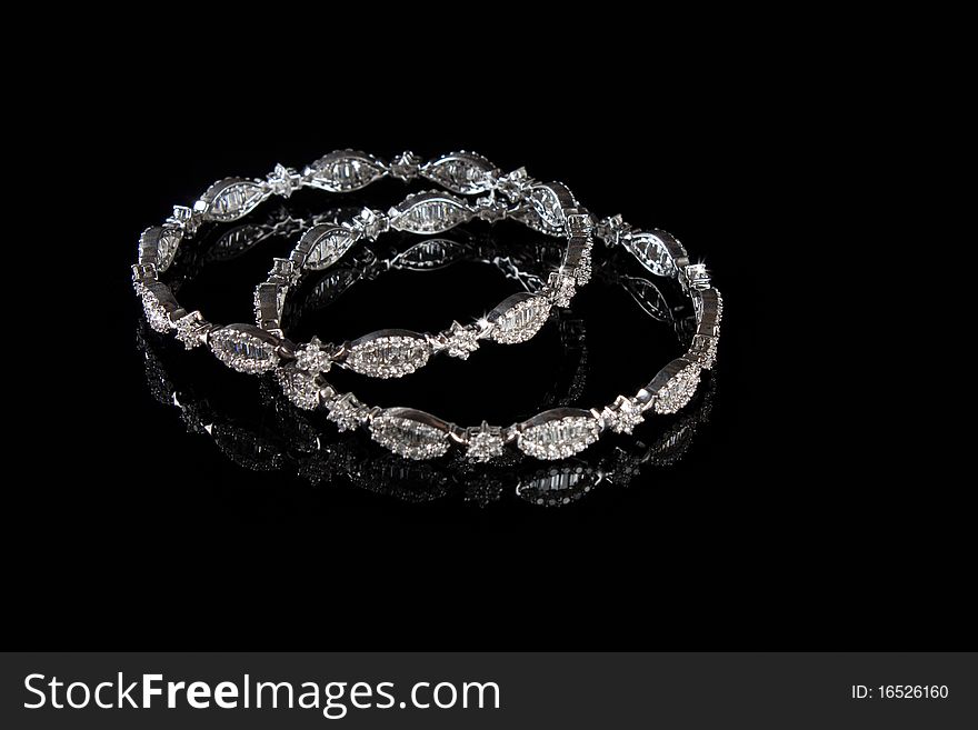 Diamond bracelet with many stones on reflective background