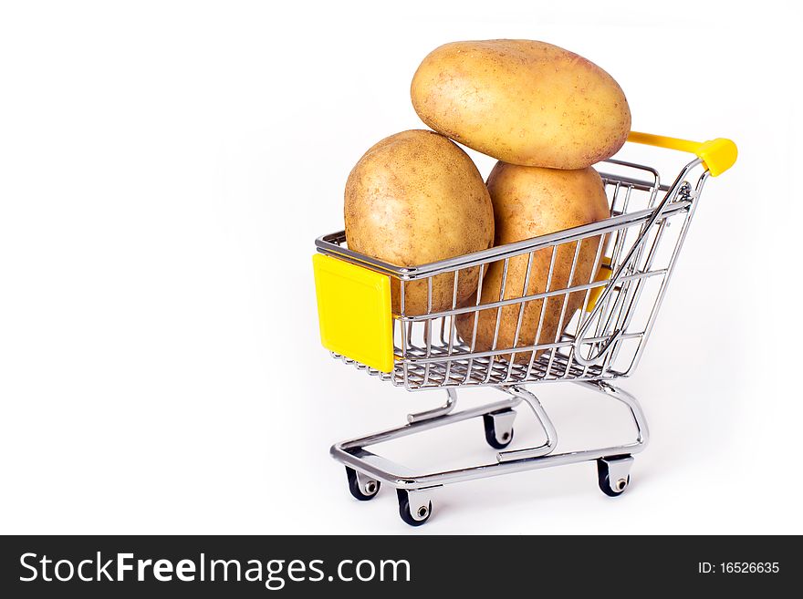 Shopping cart with three large potatoes. Shopping cart with three large potatoes