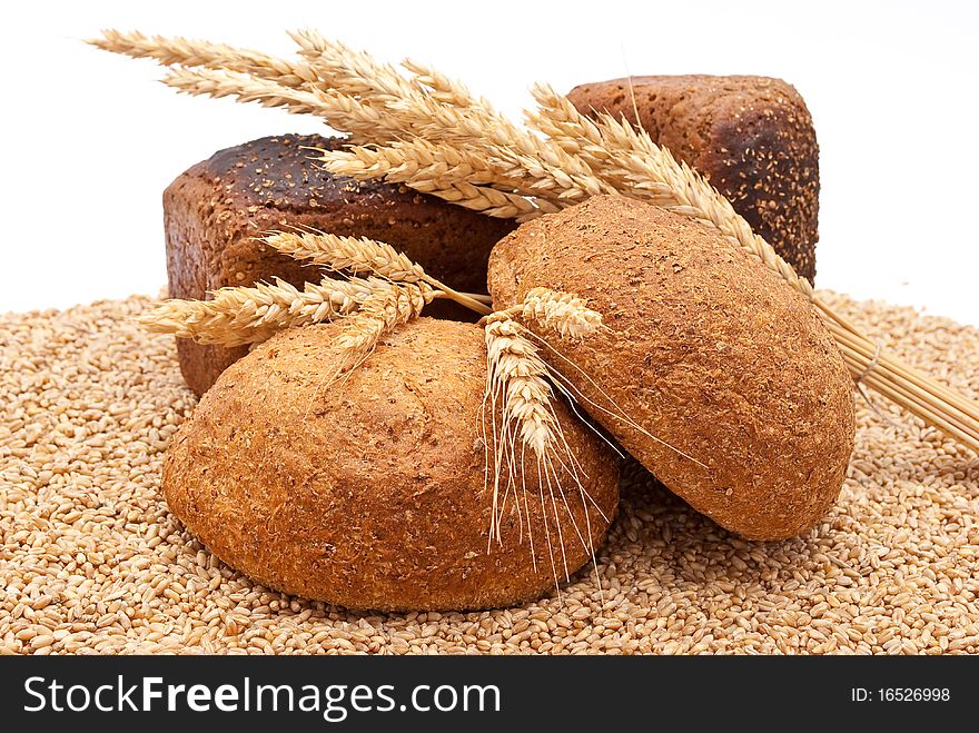 Bread with wheat and ears on white