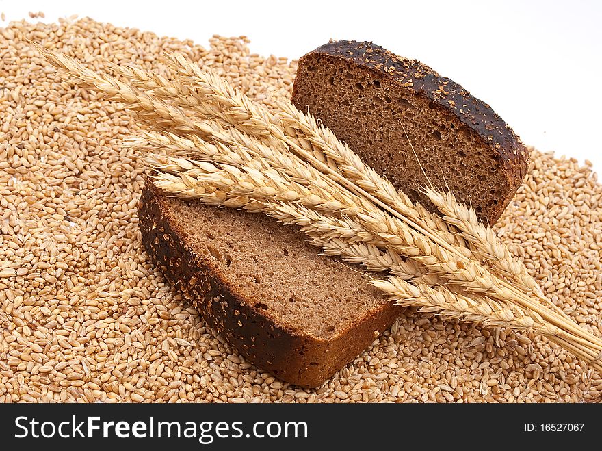 Bread with wheat and ears on white