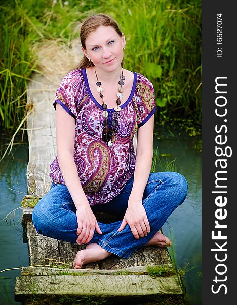 Portrait of beautiful happy pregnant woman on meadow