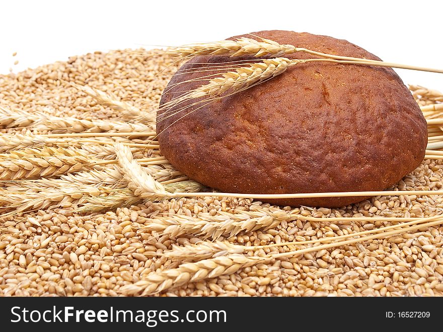 Bread with wheat and ears on white