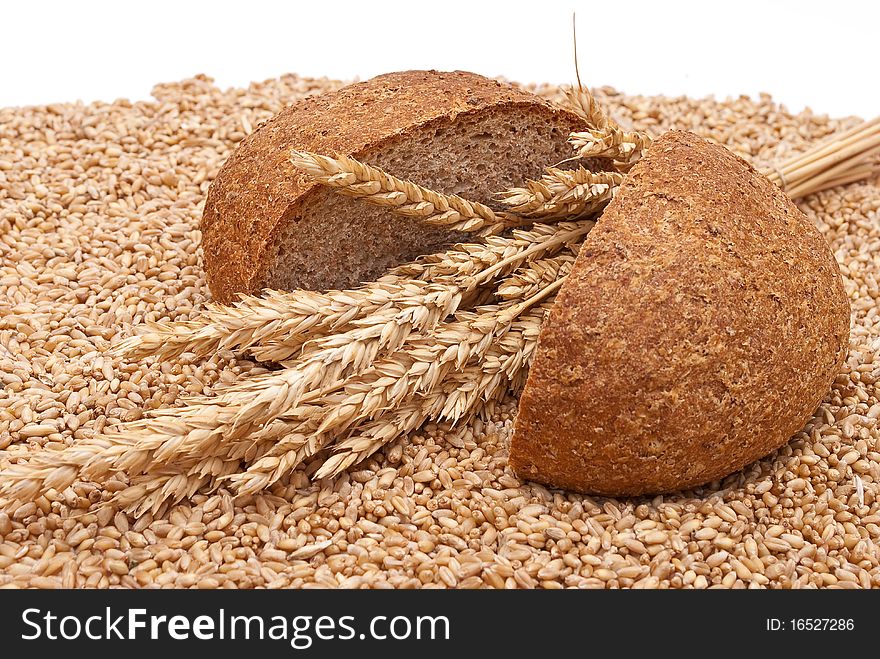 Bread with wheat and ears on white