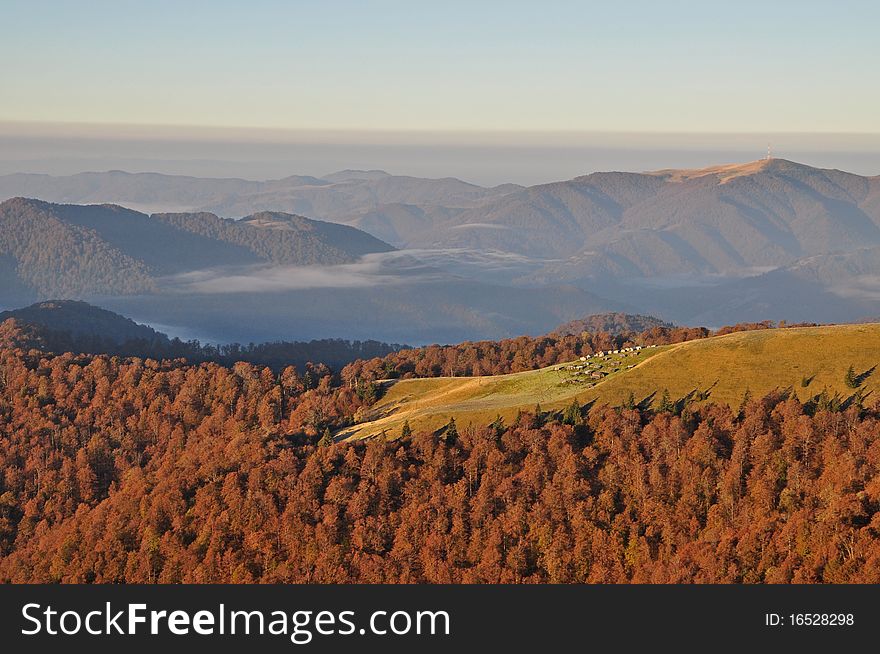 Autumn morning in mountains in a multiplane landscape with beechen woods on slopes. Autumn morning in mountains in a multiplane landscape with beechen woods on slopes