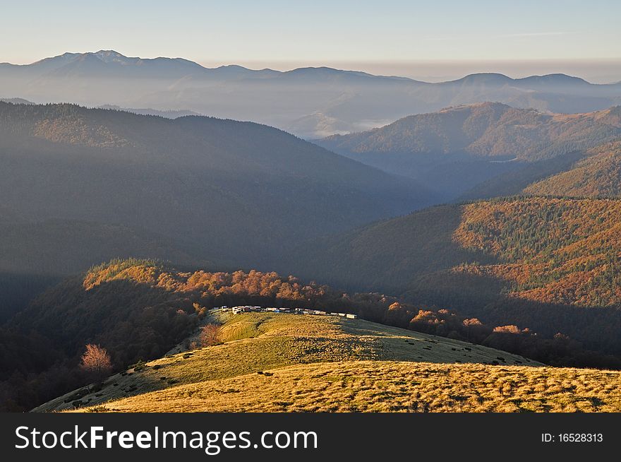 Autumn morning in mountains in a multiplane landscape with beechen woods on slopes. Autumn morning in mountains in a multiplane landscape with beechen woods on slopes