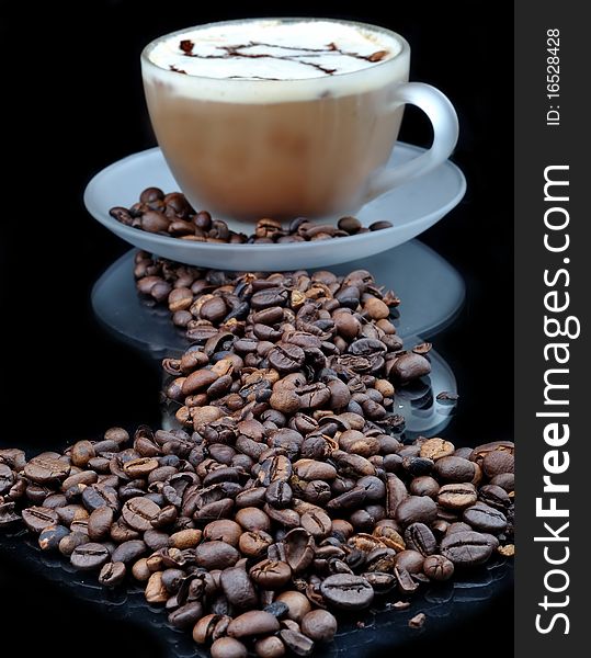 Pure glass with coffee with smoke and granules on black table. Pure glass with coffee with smoke and granules on black table