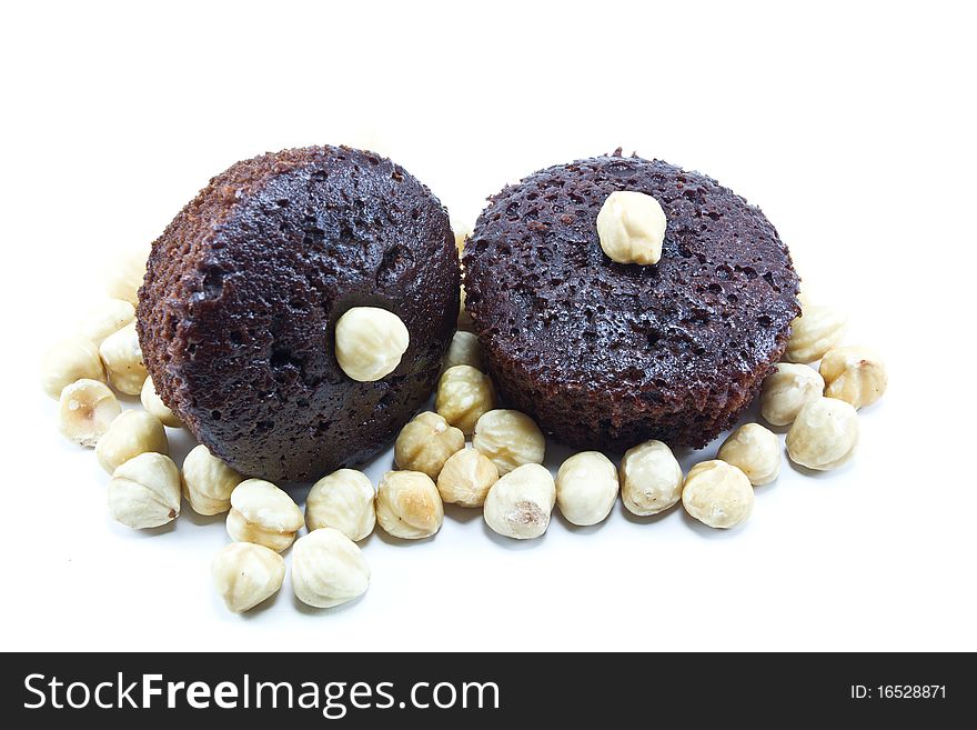 Chocolate muffins with nuts on a white background