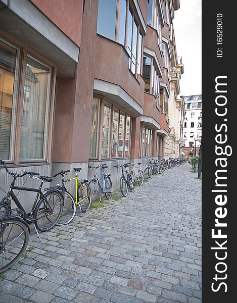 This is very typical in Stockholm, Sweden to see bikes leaning against buildings. This is very typical in Stockholm, Sweden to see bikes leaning against buildings.