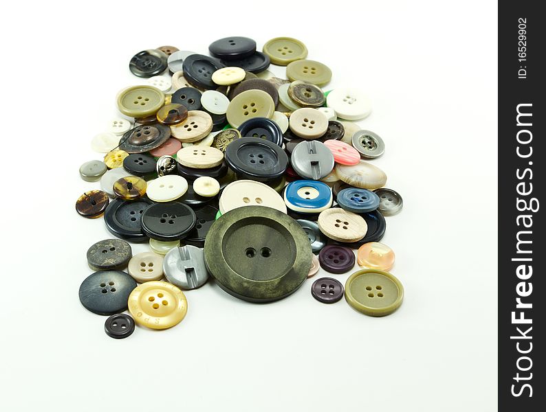 Buttons of many colors on a white background