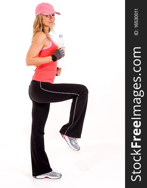 Young woman drinking water after workout