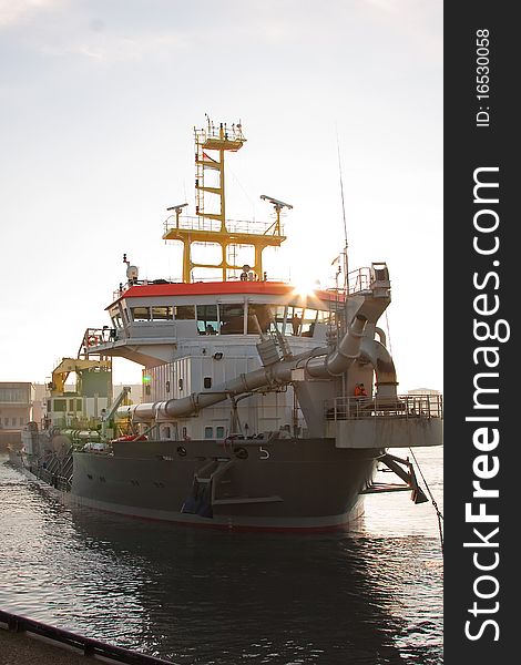 A trailing suction hopper dredger. A trailing suction hopper dredger