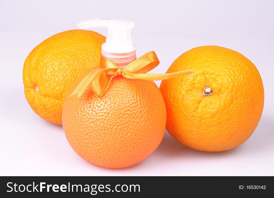 Container with liquid soap in a combination to fruit