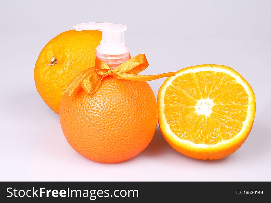 Container with liquid soap in a combination to fruit