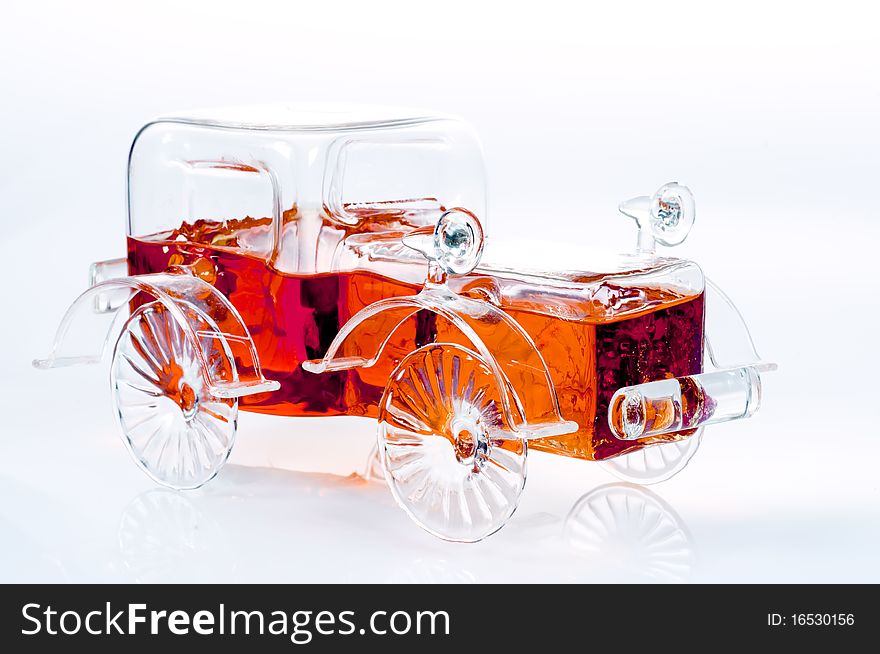 A carshaped bottle of brandy on a white background. A carshaped bottle of brandy on a white background