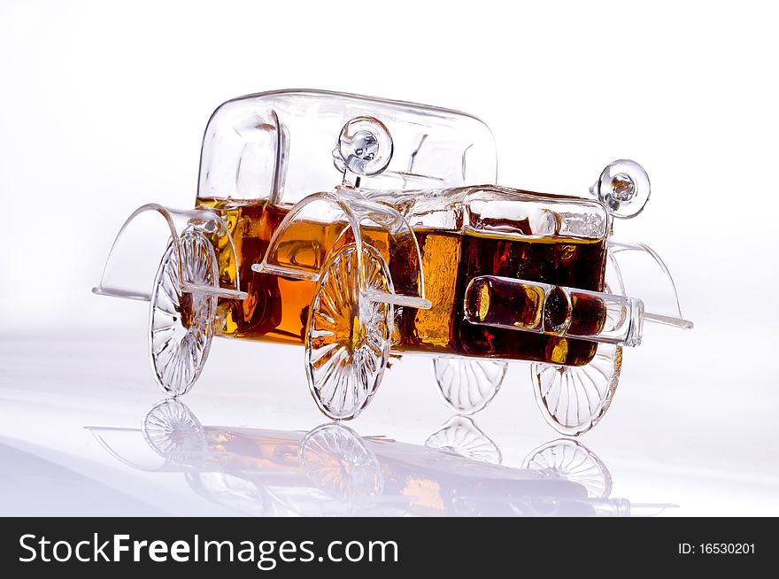 A carshaped bottle of brandy on a white background. A carshaped bottle of brandy on a white background