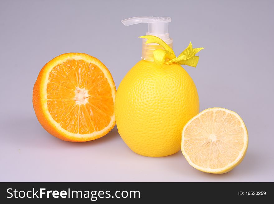 Container with liquid soap in a combination to fruit