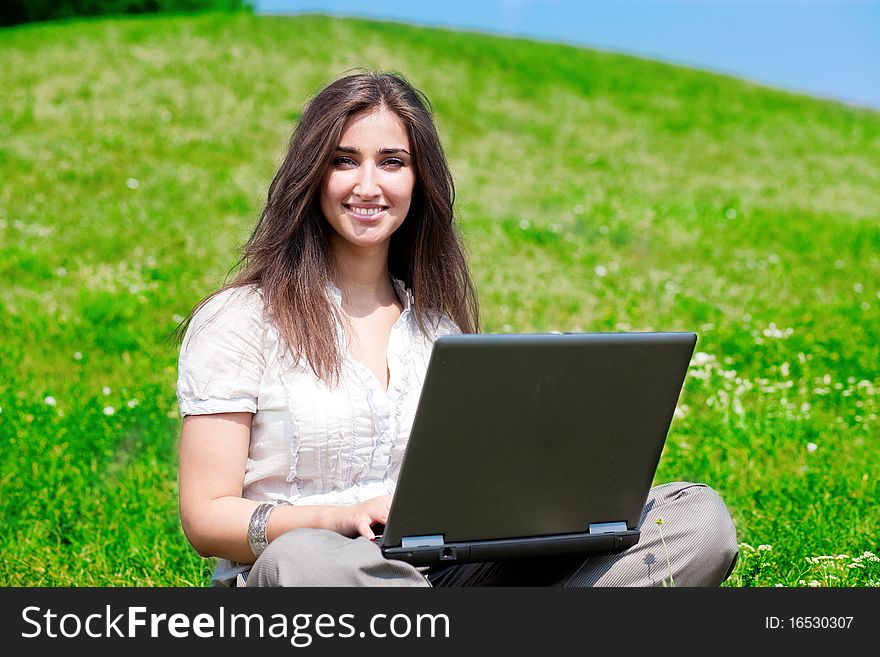 Beautiful  woman with notebook  on hill