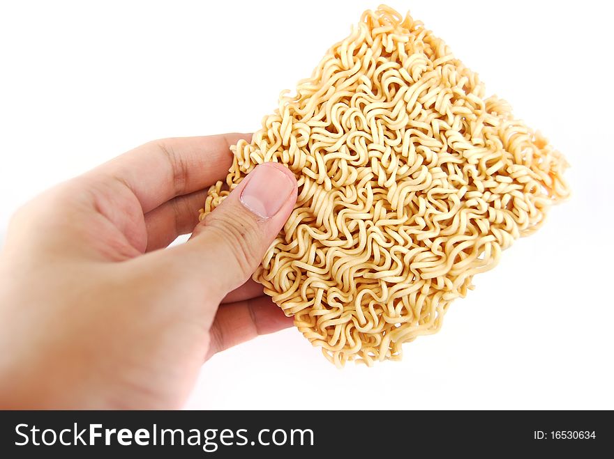 Hand holding a block of Instant noodles isolated on white background
