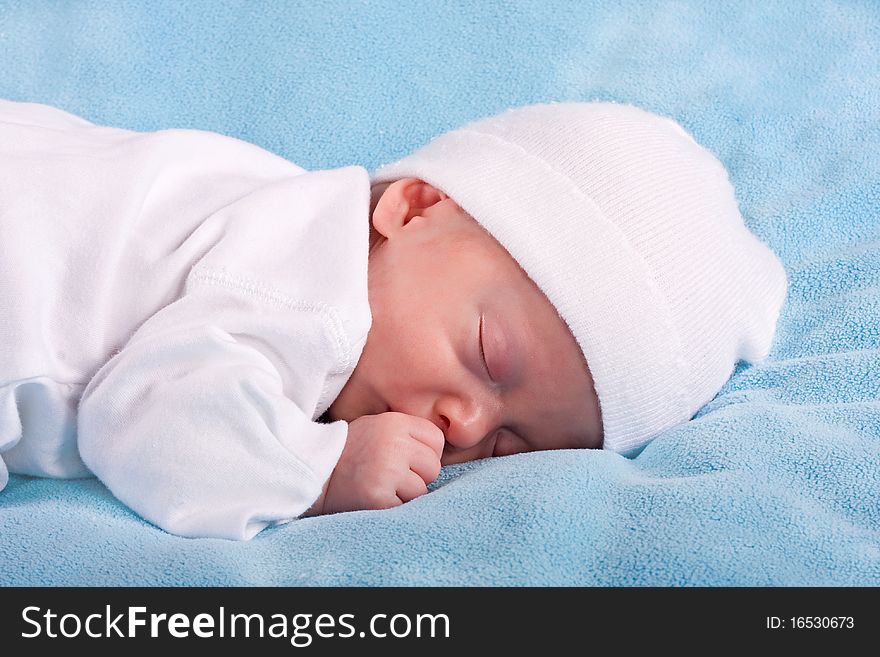 The sleeping kid on a blue background