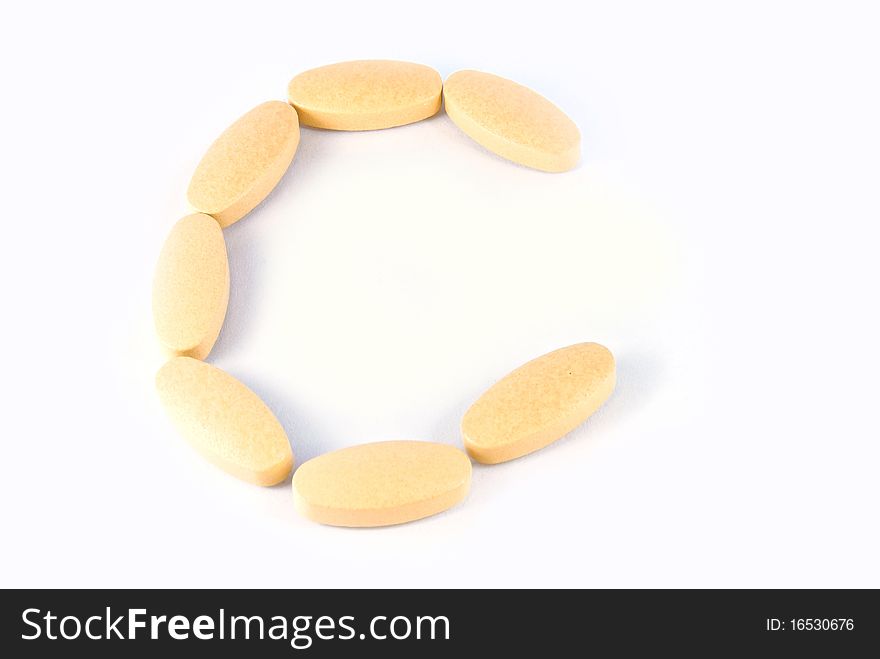 C letter from c vitamin tablets isolated