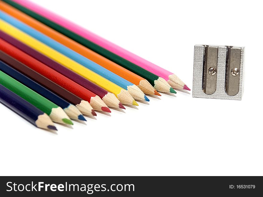 12 colored crayons with sharpener on white background. 12 colored crayons with sharpener on white background