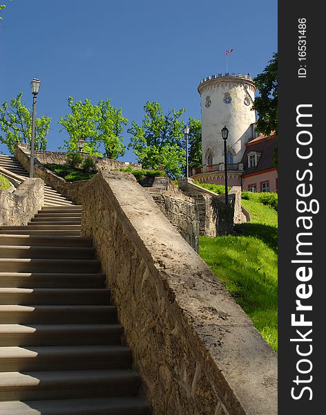 Stone stairs to round tower with flag. Stone stairs to round tower with flag