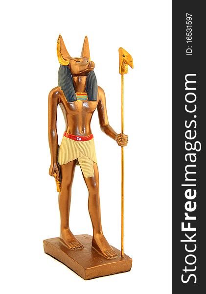 Figurine of Egyptian god anubis gold color with a staff. Figurine of Egyptian god anubis gold color with a staff