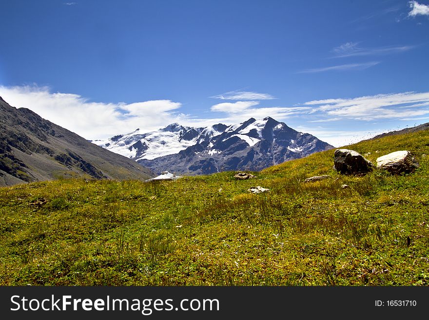 Mountains of the Valtellina with the glacier and stream