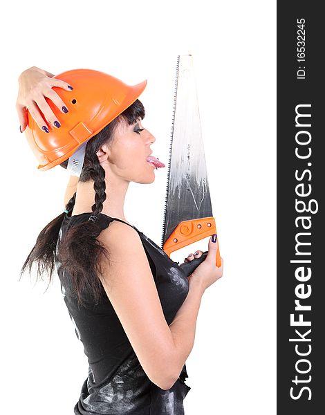 Girl in an orange hard hat licks a saw. Girl in an orange hard hat licks a saw