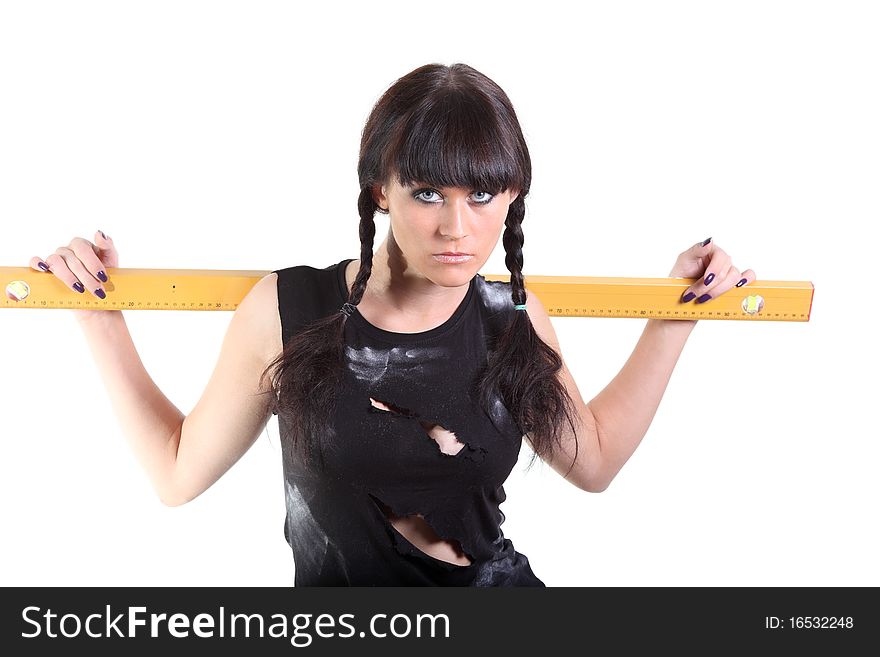 Girl in a ragged t-shirt hold a yellow ruler. Girl in a ragged t-shirt hold a yellow ruler