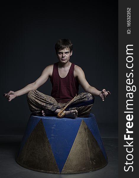 Circus actor posing on curbsone in studio