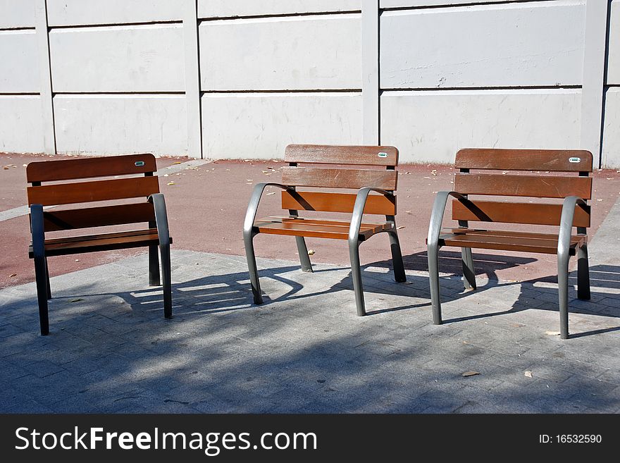 View of three benches in a park. View of three benches in a park