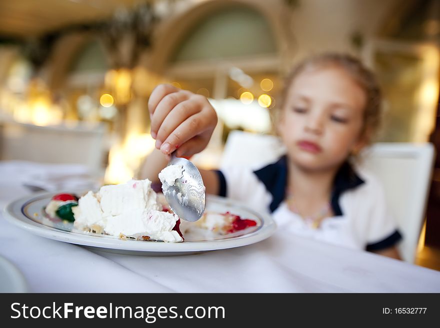 Little Girl Eating A Cake