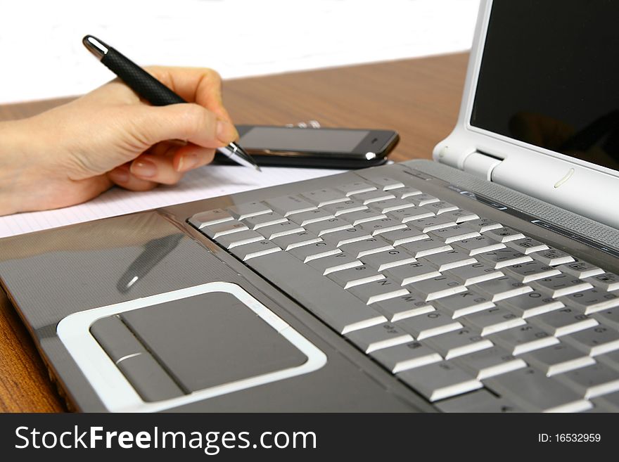 Business Man with laptop and Handheld, signing paper,. Business Man with laptop and Handheld, signing paper,