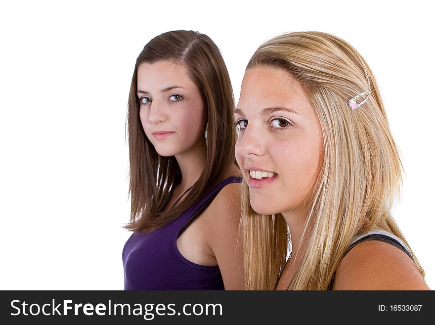 Two young girl friends smiling - isolated over white background. Two young girl friends smiling - isolated over white background.