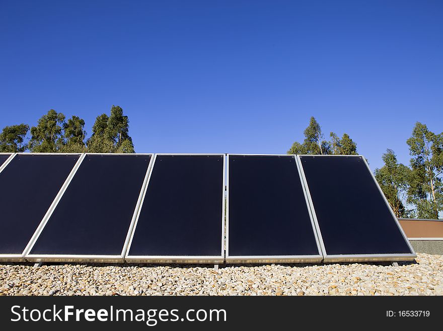 Solar panels on the roof against blue sky