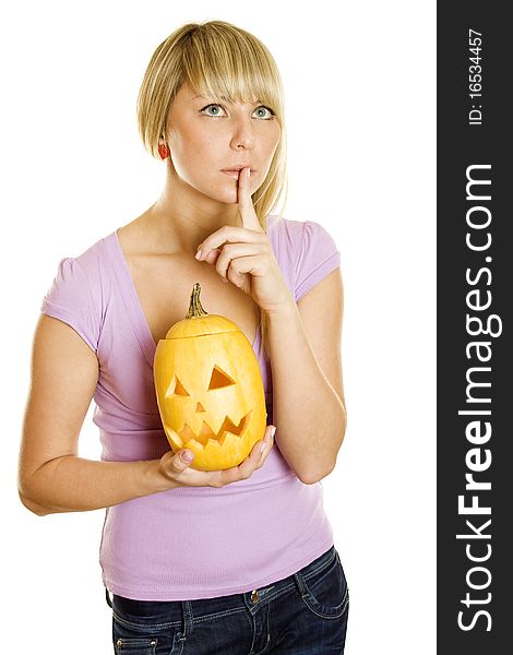 A young girl frightened with pumpkin for Halloween. Gesturing for Quiet or Shushing. Lots of copyspace and room for text on this isolate. A young girl frightened with pumpkin for Halloween. Gesturing for Quiet or Shushing. Lots of copyspace and room for text on this isolate