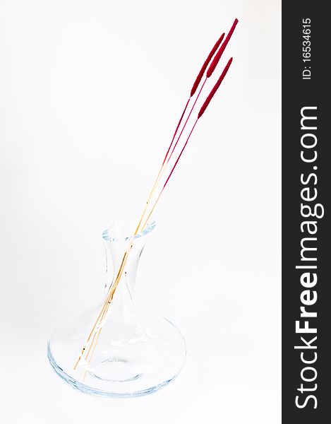 Decorative glass vase with red dried grass