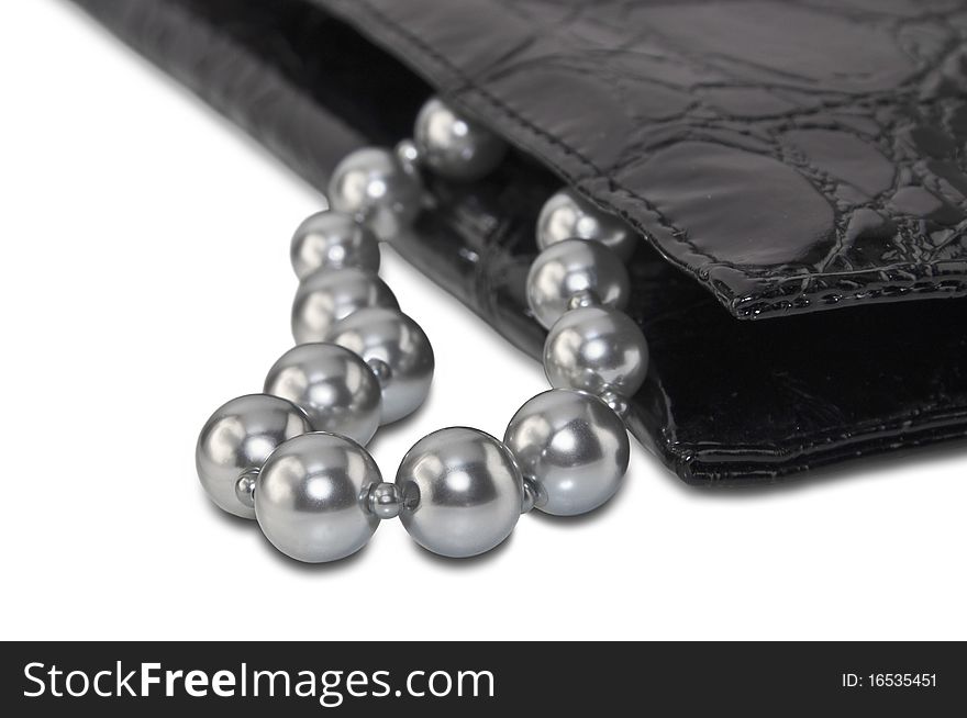 Gray beads and black handbag isolated on a white background