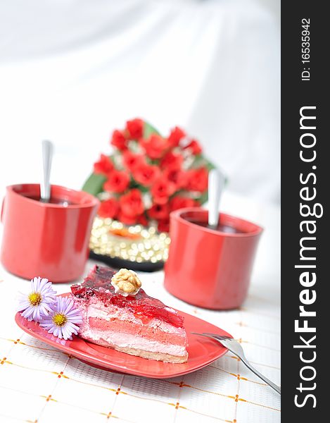 Fruit dessert with tea, red roses and napkin in red concept. Fruit dessert with tea, red roses and napkin in red concept