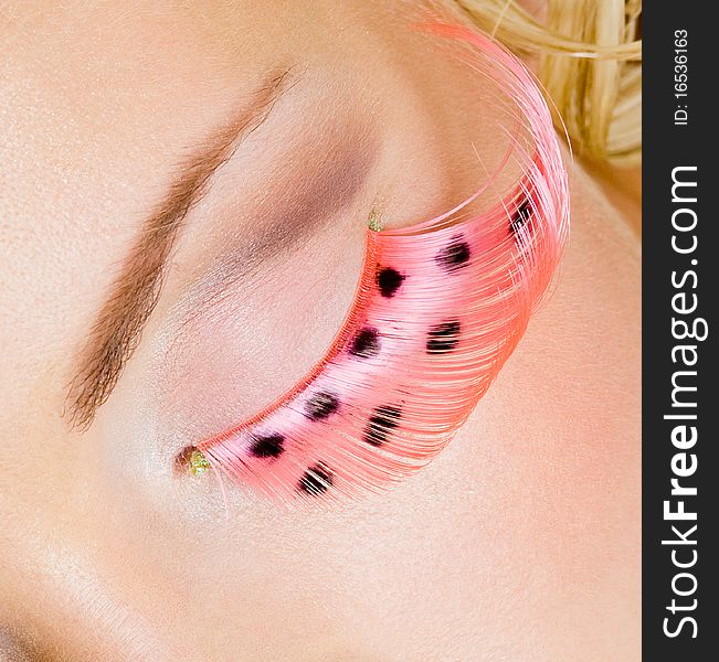 Pink eye make-up with false eyelashes - macro shot