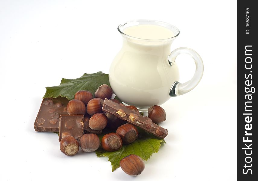 Chocolate hazelnut and milk jug on a white background. Chocolate hazelnut and milk jug on a white background