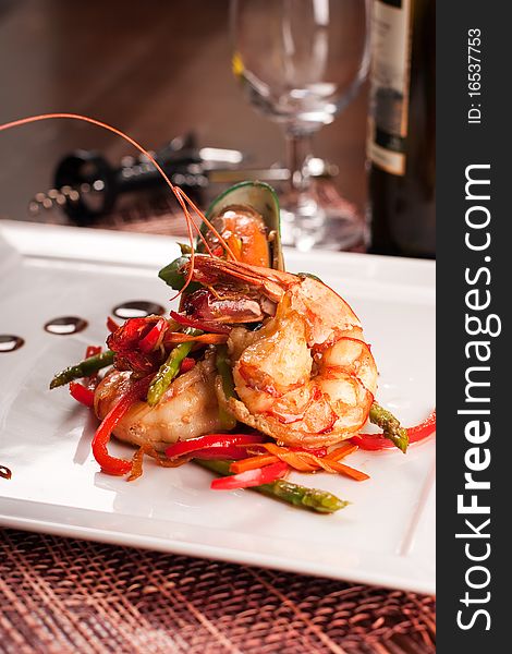 Delicatessen dish with tiger shrimps, mussels and vegetables. Delicatessen dish with tiger shrimps, mussels and vegetables