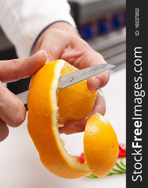 Peeling off orange by cook