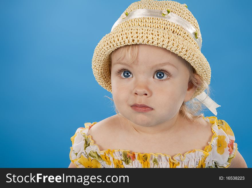 Lovely little girl in a hat looks upwards. Lovely little girl in a hat looks upwards