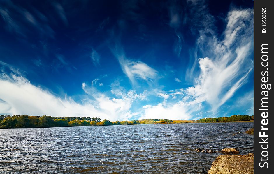 Wonderful autumn lake and blue sky with white clouds. Wonderful autumn lake and blue sky with white clouds.